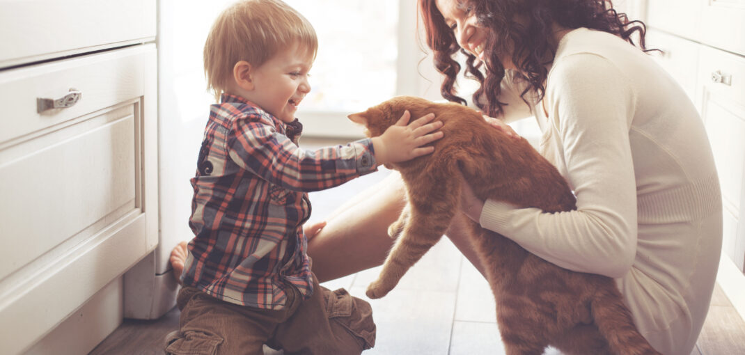 Mom and toddler kneeling on kitchen floor