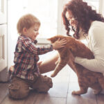 Mom and toddler kneeling on kitchen floor