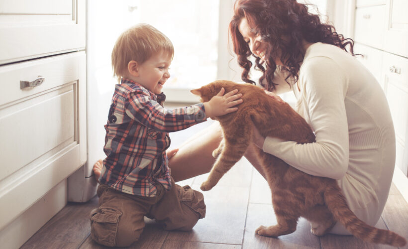 Mom and toddler kneeling on kitchen floor