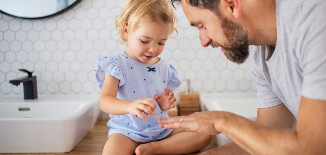 Dad and daughter in small new bathroom in Cypress, TX