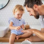 Dad and daughter in small new bathroom in Cypress, TX