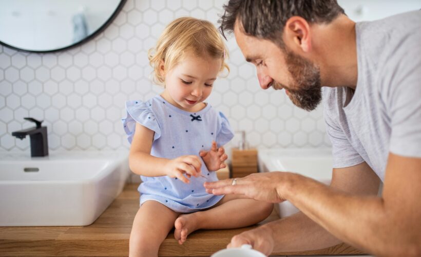 Dad and daughter in small new bathroom in Cypress, TX